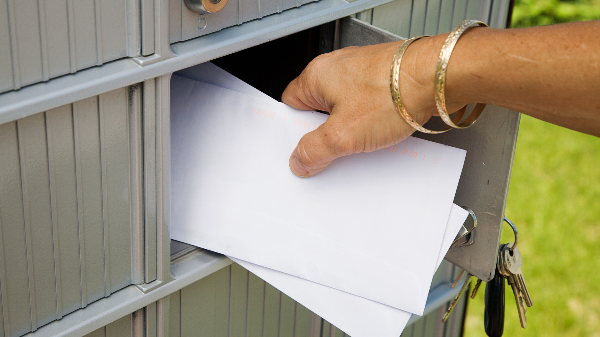 person getting the mail from the mailbox